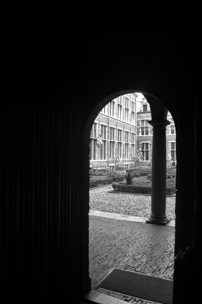 Heavy wooden door leading to the Plantin Moretus court yard/ another universe.